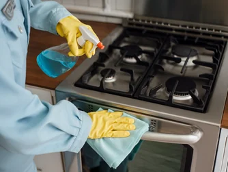 Operaria limpiando la cocina de un departamento de 50 m² en Lima
